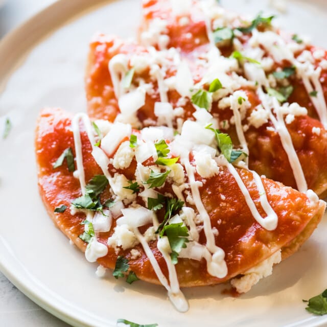 Entomatadas topped with queso fresco and Mexican crema.