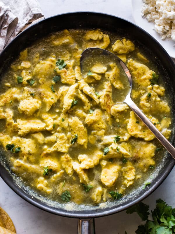 Huevo en chile verde (or scrambled eggs in a salsa verde) in a skillet.