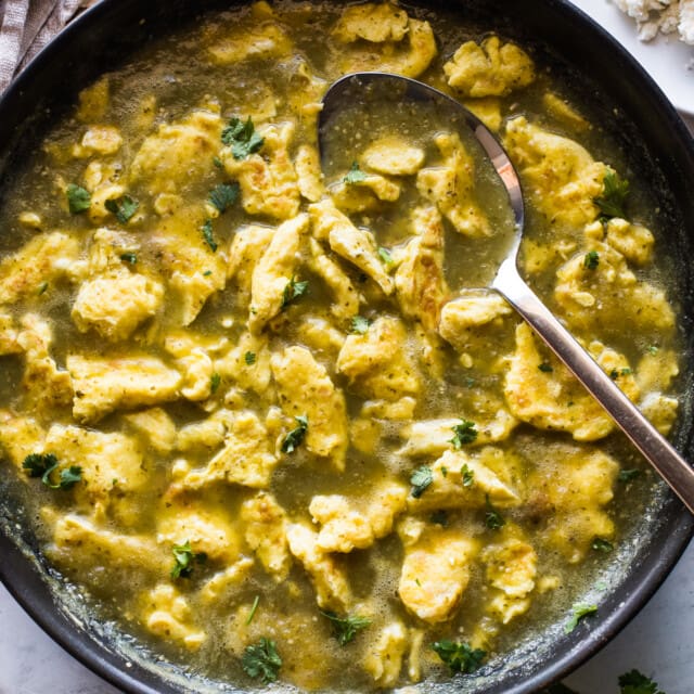 Huevo en chile verde (or scrambled eggs in a salsa verde) in a skillet.