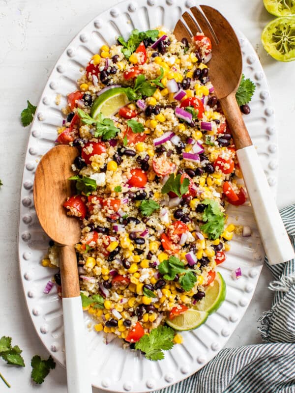 Mexican Quinoa Salad topped with cilantro and served with lime wedges.