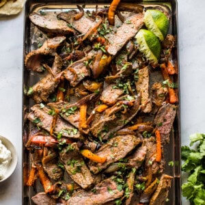 Sheet pan steak fajitas topped with cilantro.