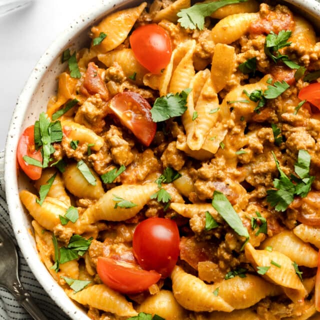 Taco pasta in a bowl garnished with cilantro.