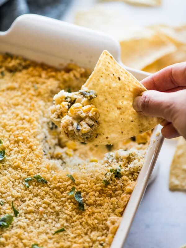 Chile relleno dip on a tortilla chip.