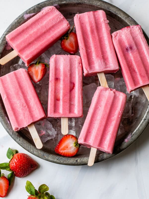 Strawberries and cream popsicles ready to be eaten.