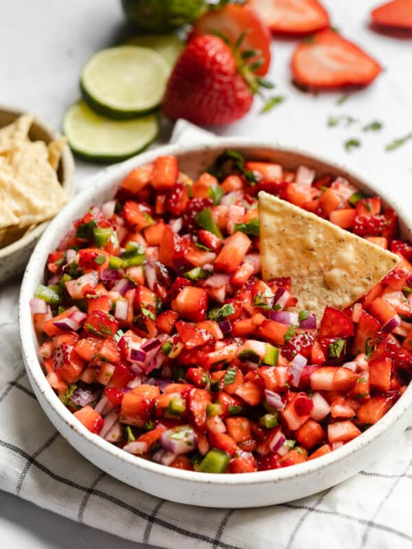 Strawberry Salsa in a bowl next to tortilla chips.