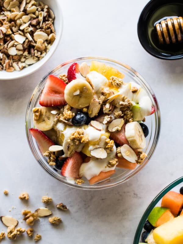 A bionico Mexican fruit bowl topped with honey and granola.