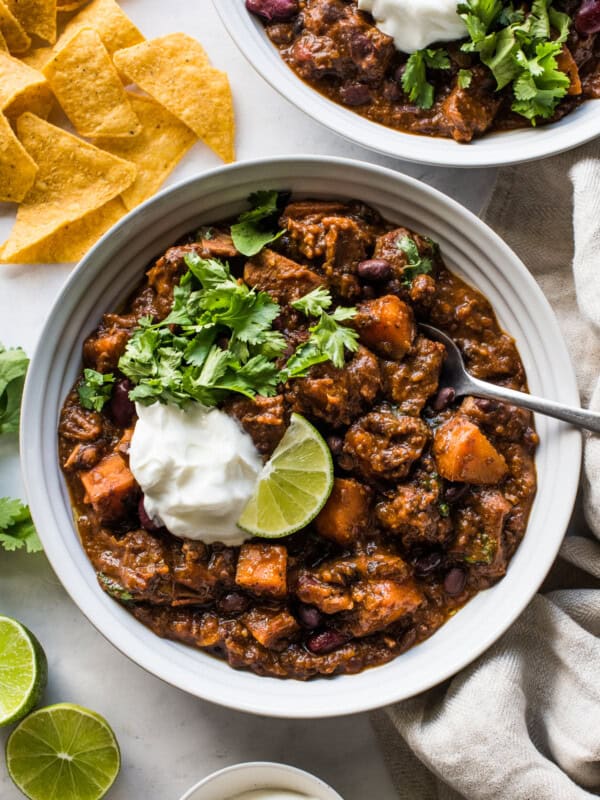 Pork chili in a bowl made from beans, sweet potatoes, pork shoulder, and chipotle spices.