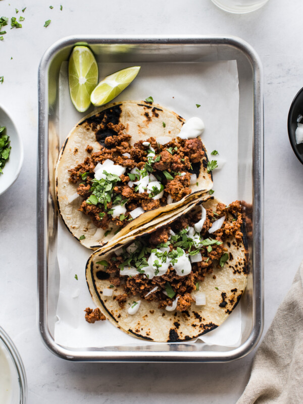 Chorizo tacos topped with lime crema and cilantro.