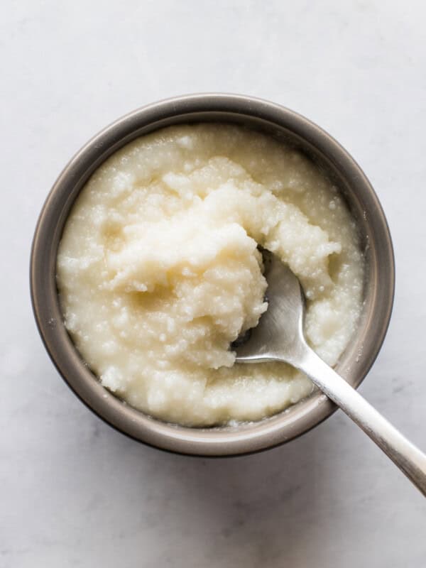 Lard in a small bowl with a spoon.