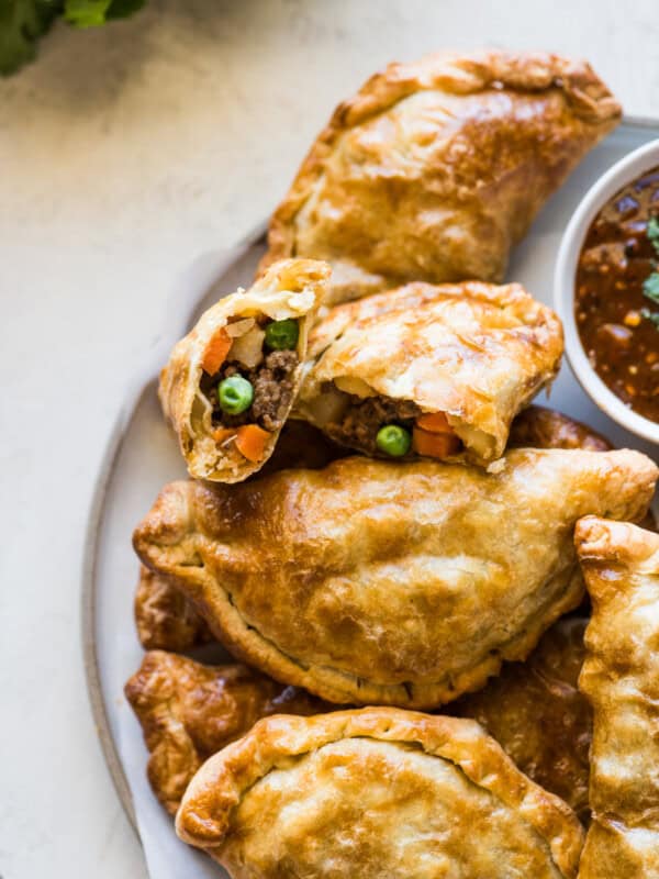 Air fryer empanadas filled with ground beef, potatoes, peas, and carrots.