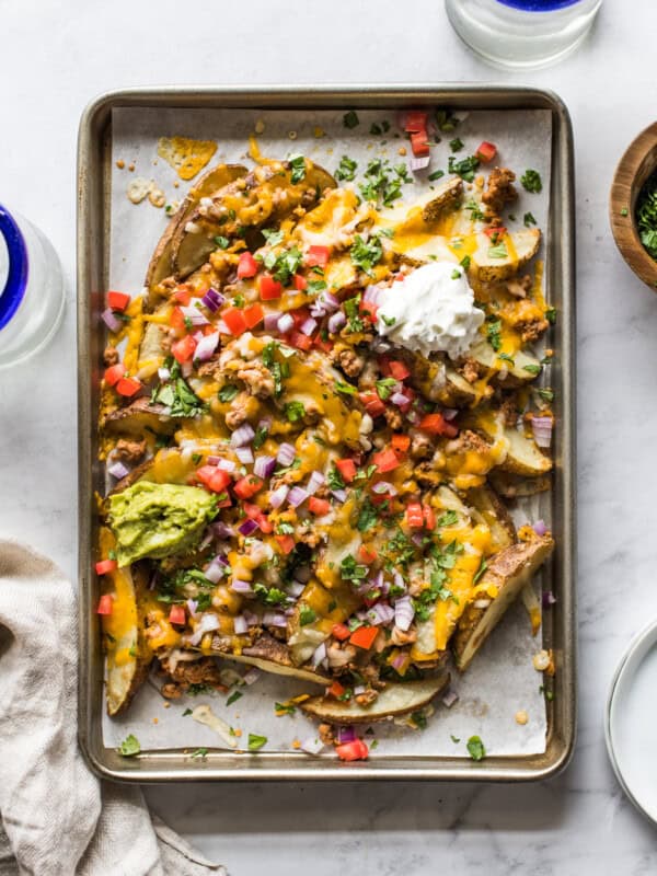 Loaded baked potato wedges made from potato wedges covered in melted cheese.