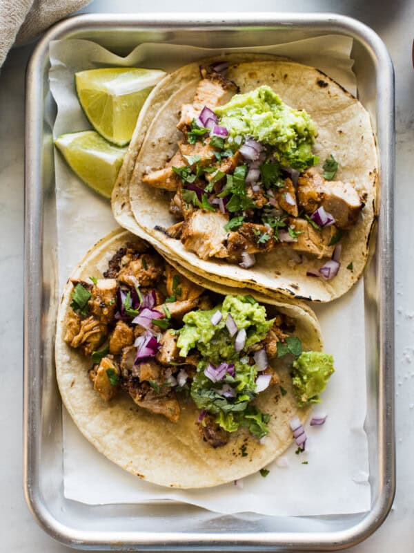 Easy chicken tacos recipe made with tender and juicy diced chicken and topped with avocado, onions, and lime juice.