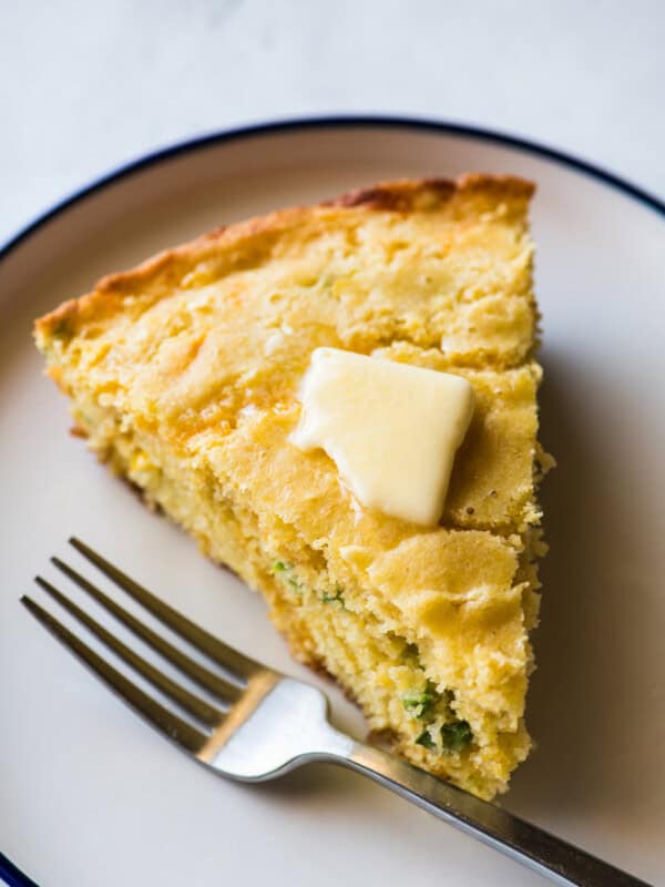 A slice of Jalapeño Cornbread with a pat of melted butter on top.