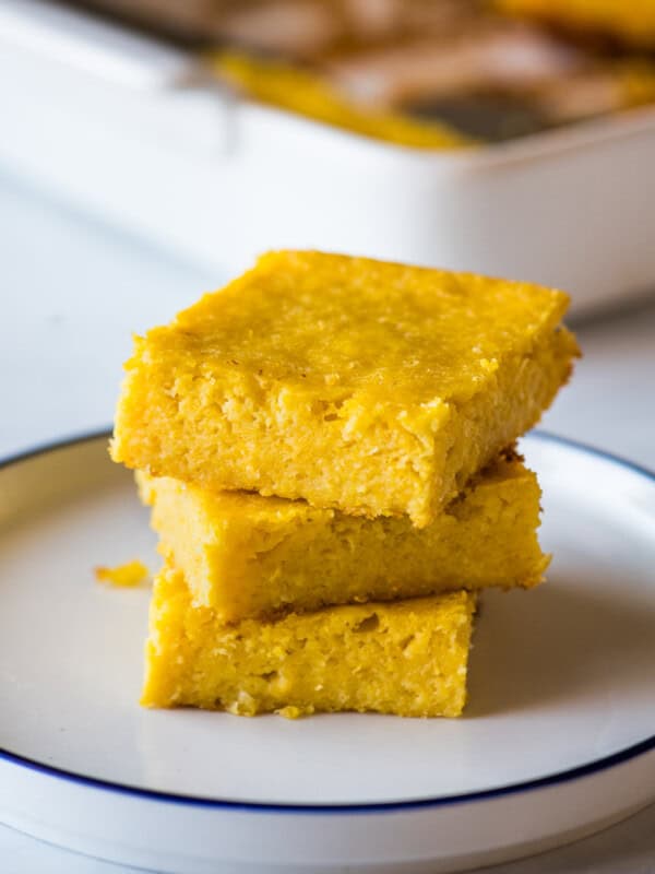 Pan de Elote stacked on top of one another on a plate.