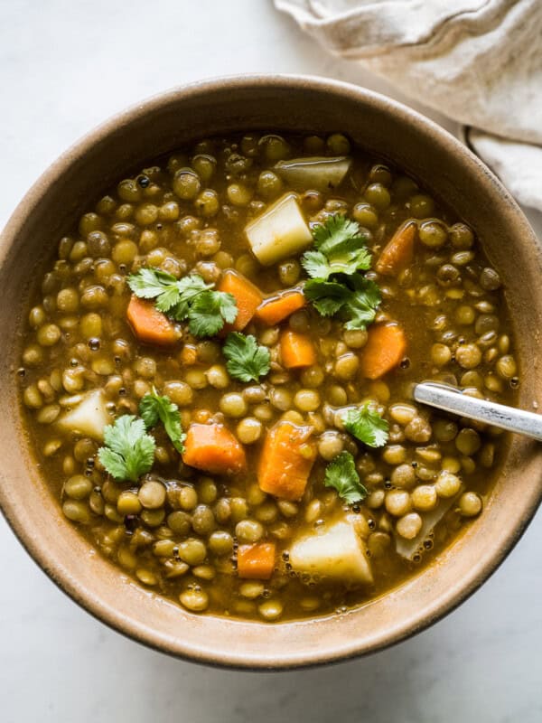 A bowl of lentejas (Mexican lentil soup) topped with cilantro.