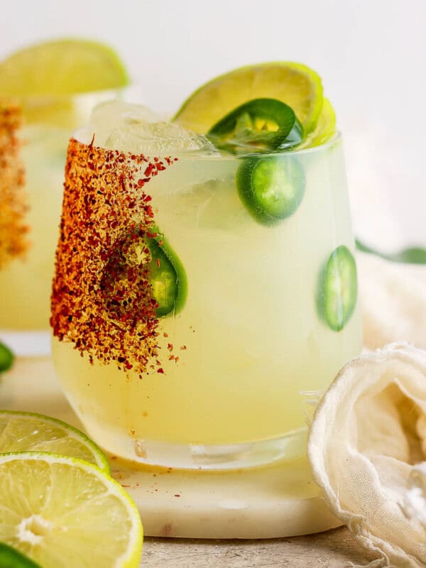 Spicy margarita in a glass rimmed with tajin.