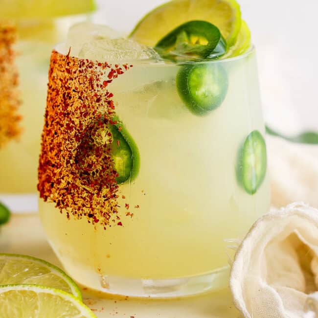 Spicy margarita in a glass rimmed with tajin.