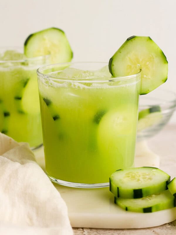 Agua de pepino (Mexican cucumber agua fresca) in glasses garnished with cucumber slices.