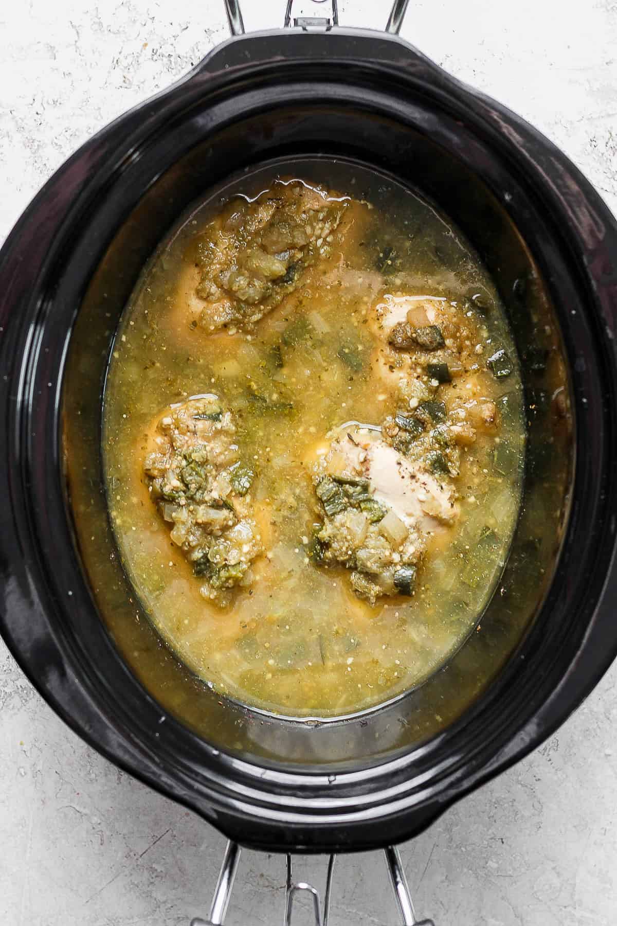 Cooked salsa verde chicken inside the crockpot
