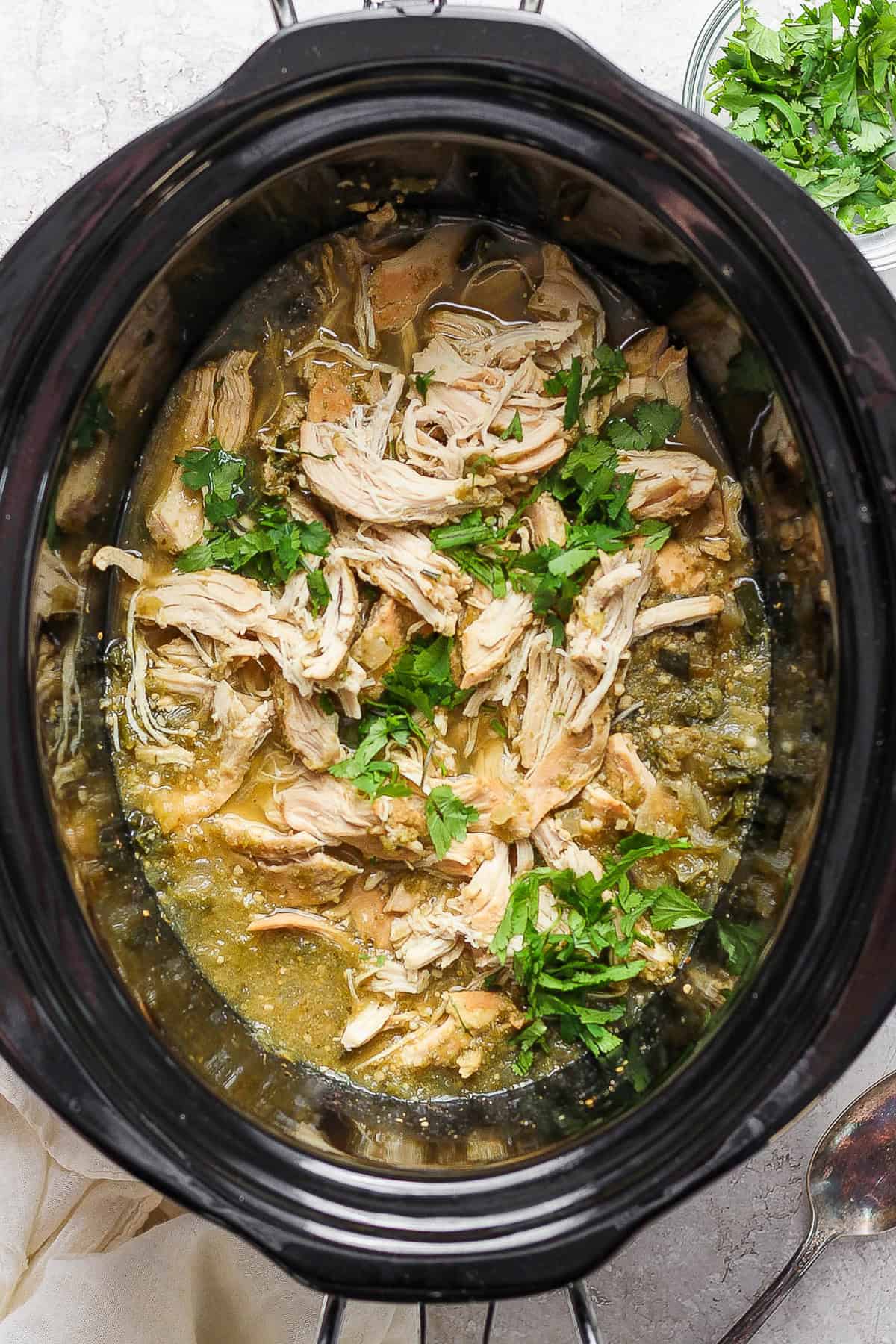 Salsa verde chicken cooked and ready to eat inside the crockpot