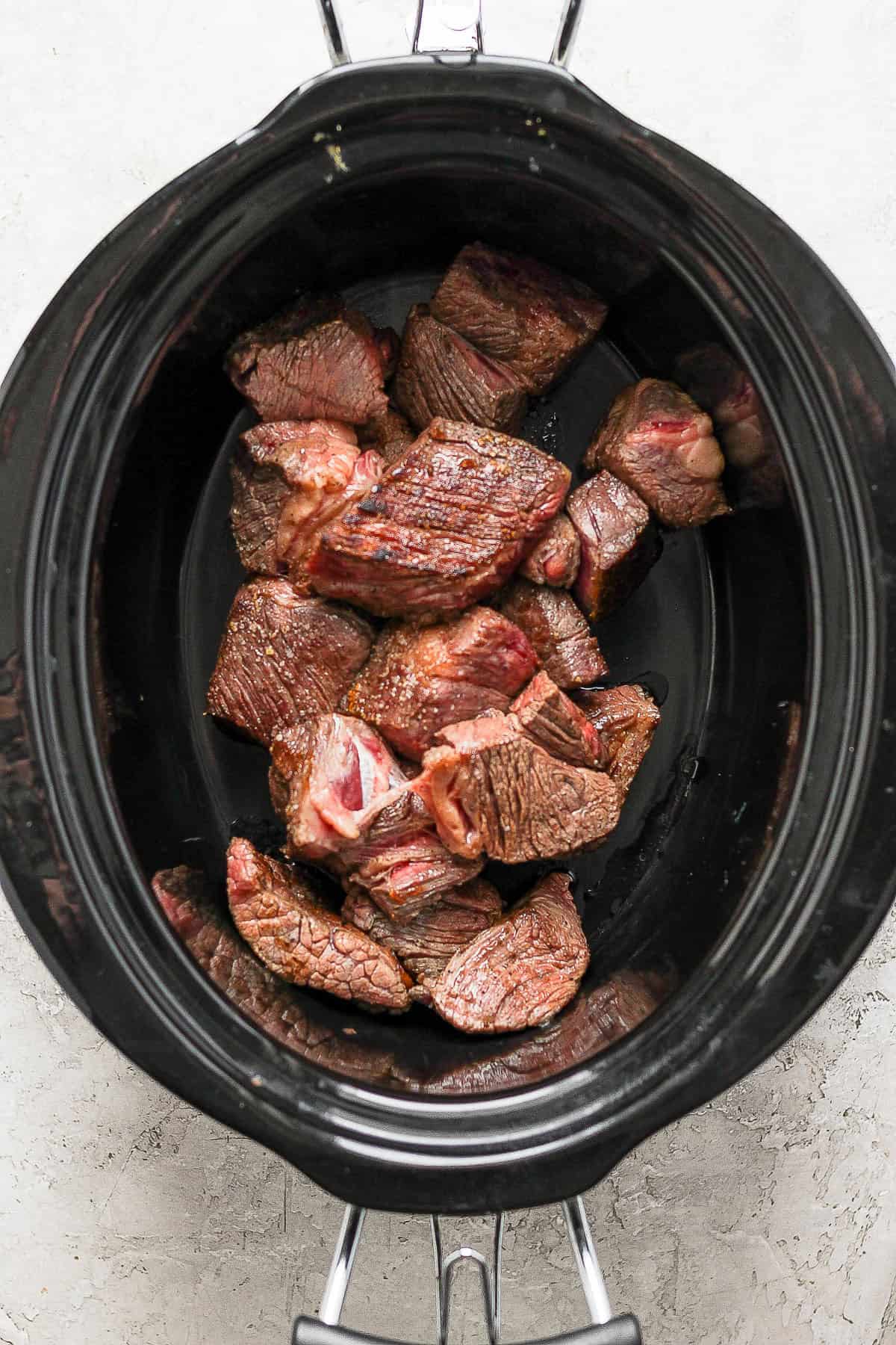 Cooked beef inside the crockpot
