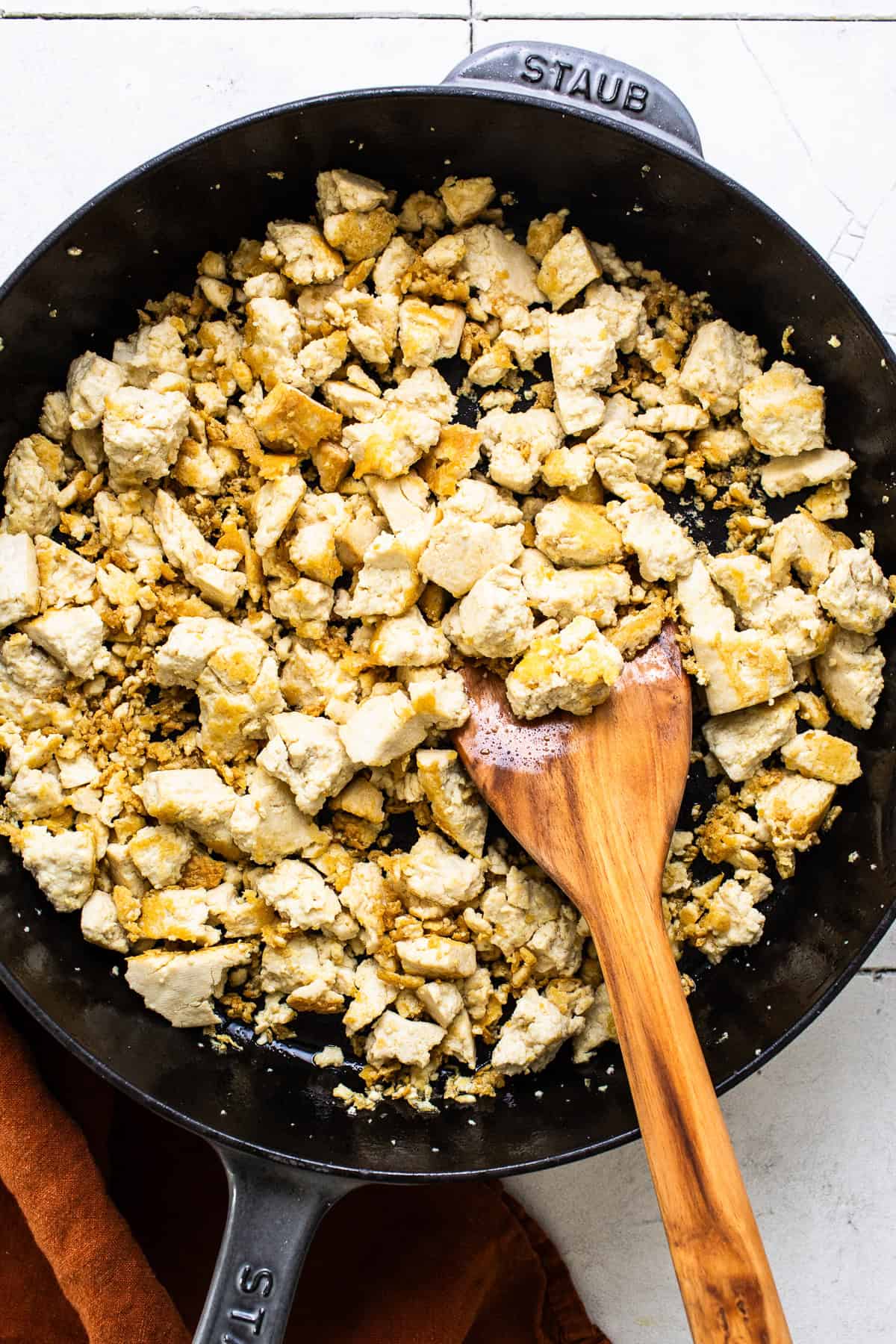 Crumbled tofu heating in a large skillet 