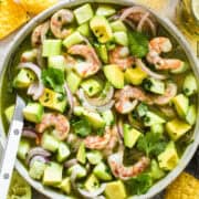 Aguachile in a bowl with tortilla chips on the side.