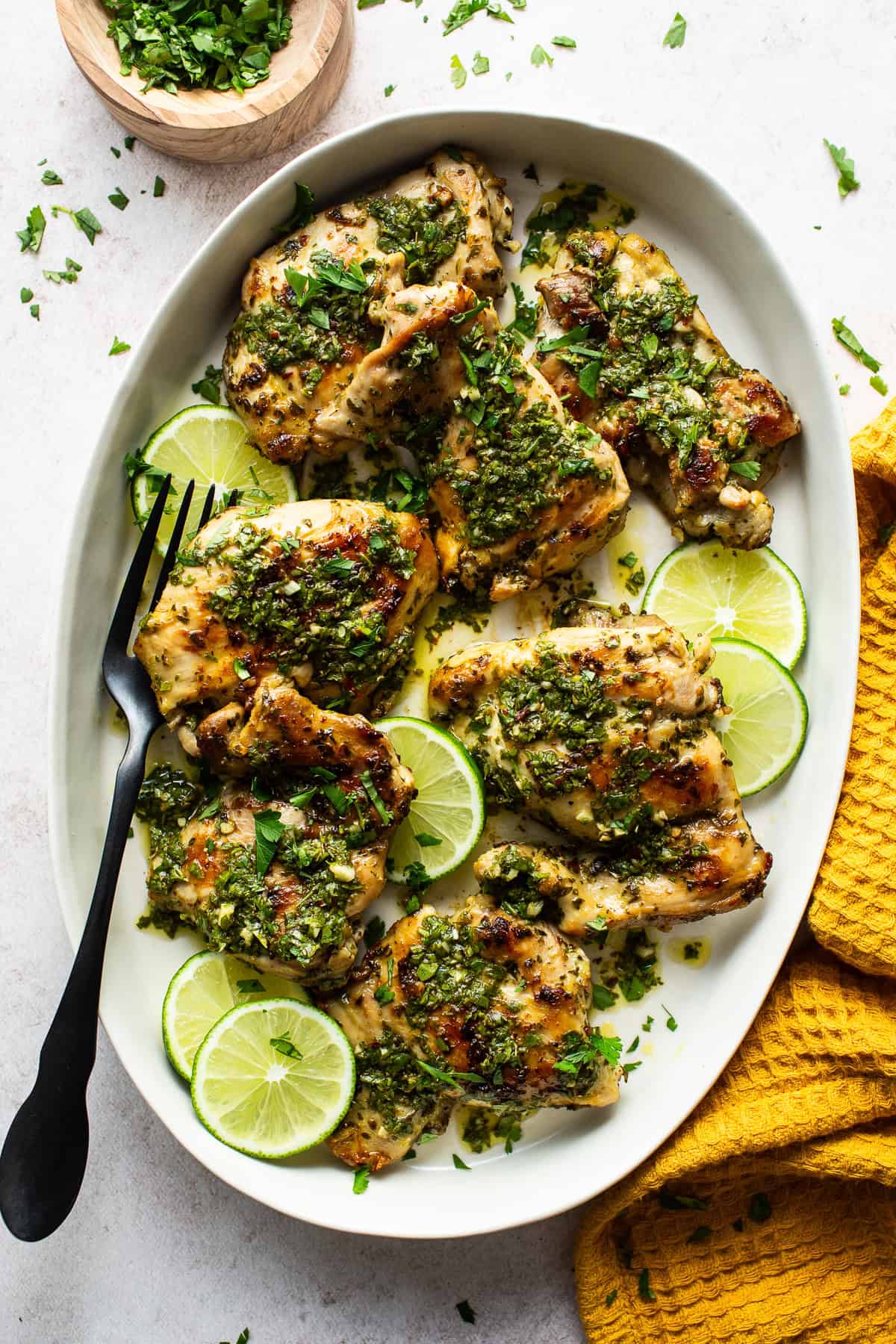 Chimichurri chicken served on a plate with lime slices