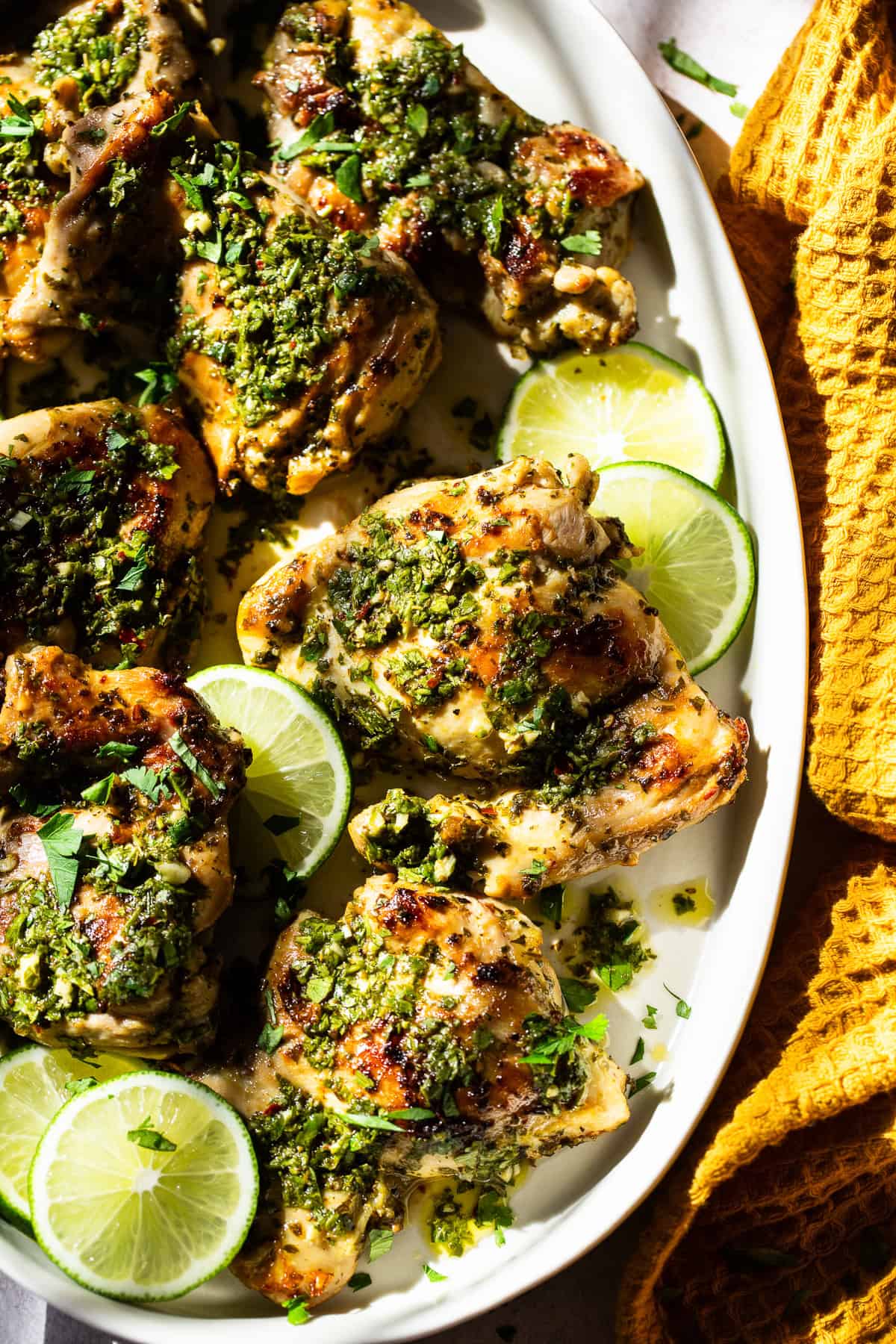 Served chimichurri chicken with lime slices