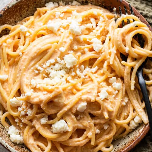 Espagueti Rojo in a bowl garnished with crumbled cotija cheese.