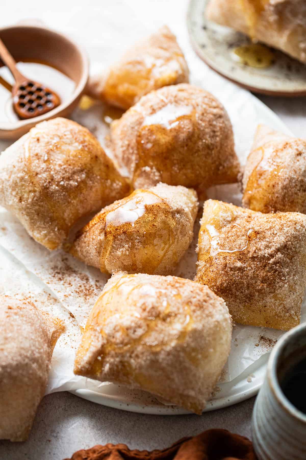 Sopapillas fully cooked, covered with cinnamon sugar, and drizzled with honey.