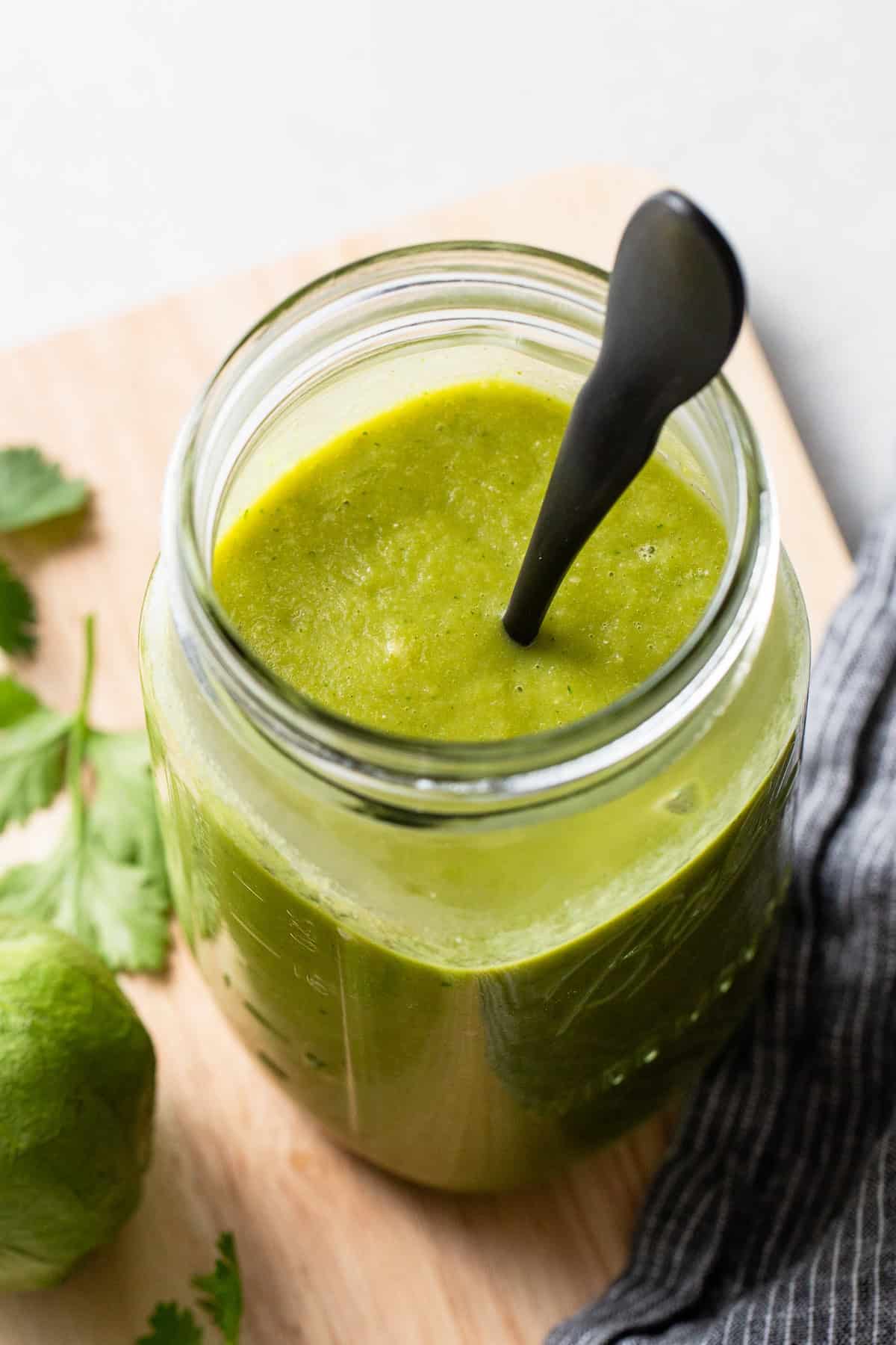 Green enchilada sauce stored in a jar