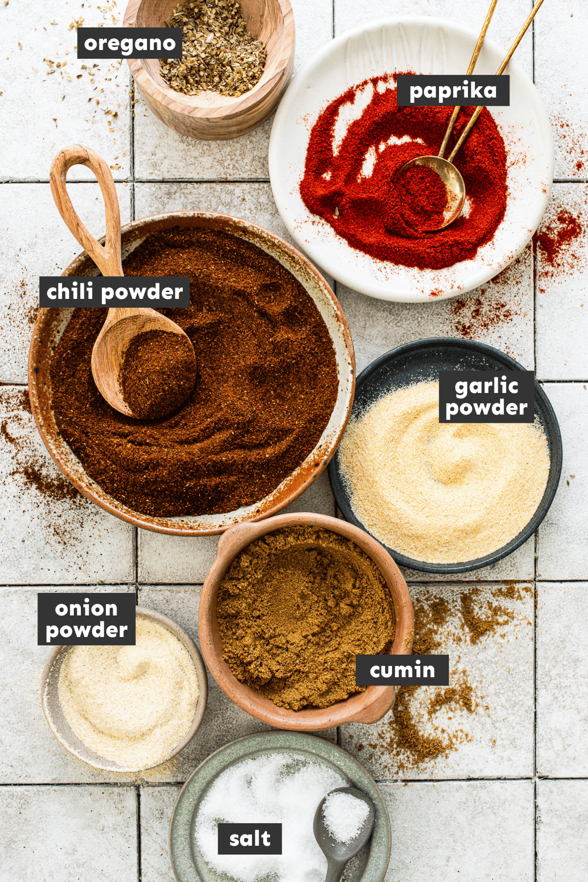 Homemade taco seasoning ingredients separated and measured in mixing bowls.