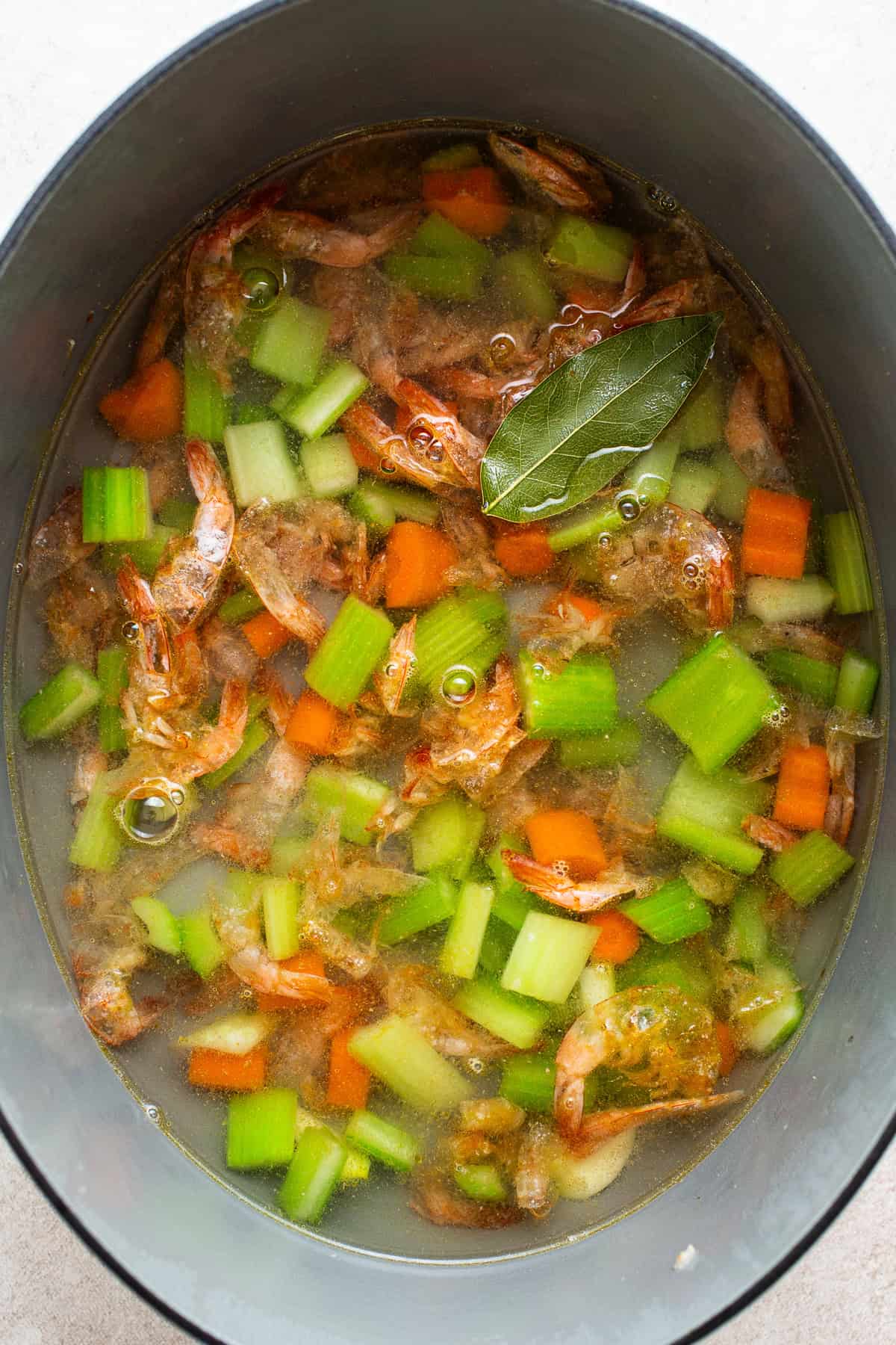 Homemade shrimp broth boiling in a pot 