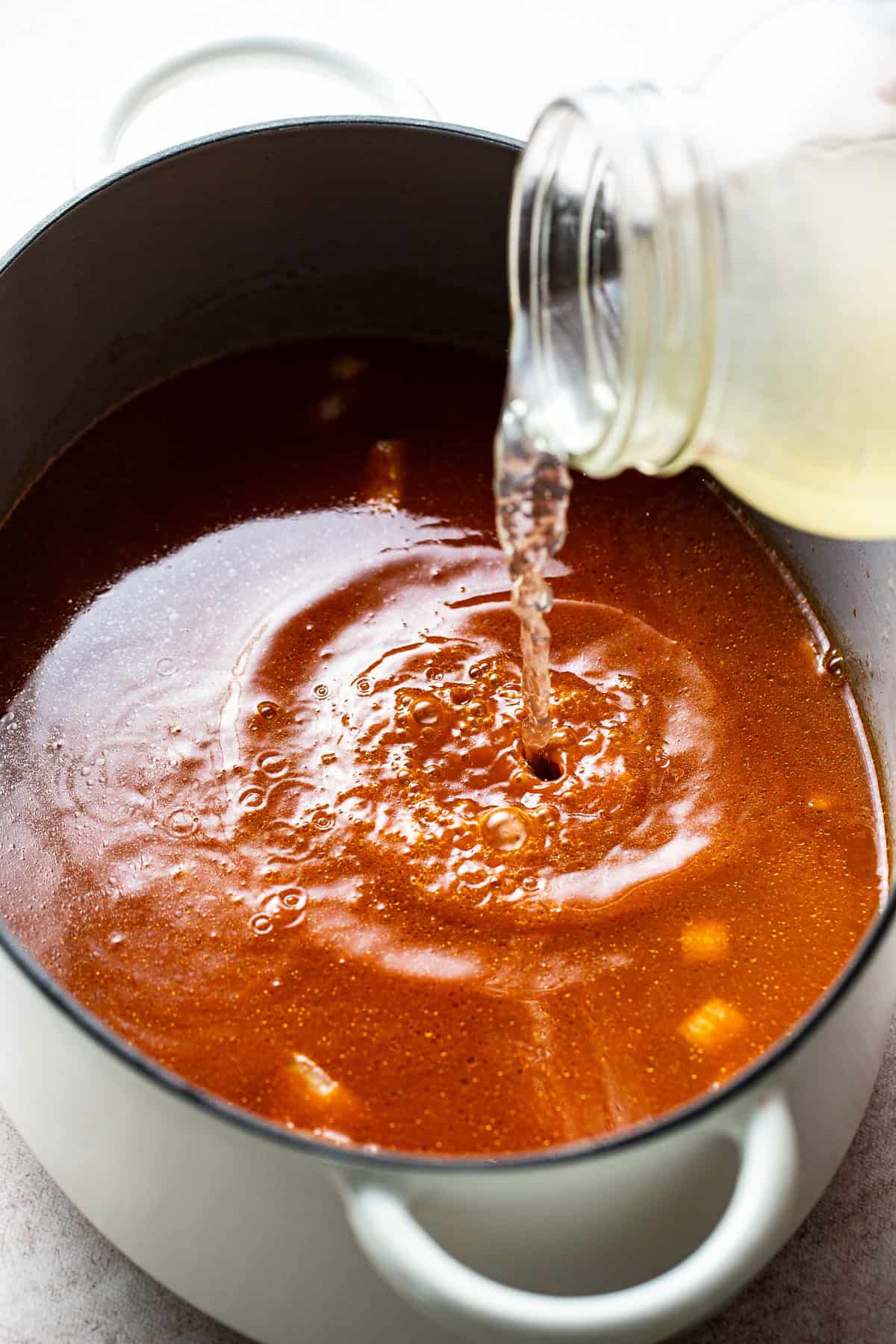 Add homemade shrimp broth to chile sauce