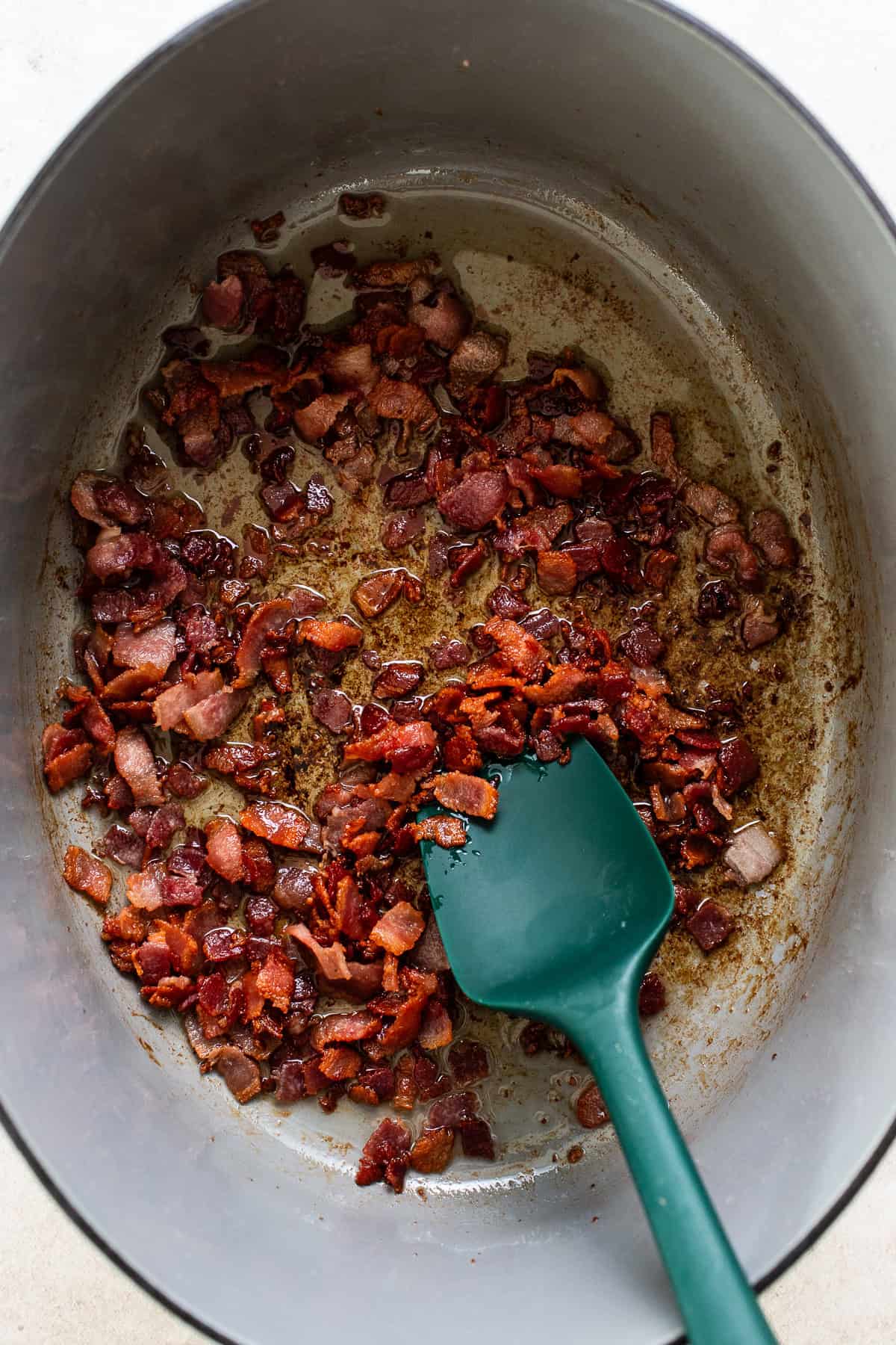 Bacon in a large dutch oven cooked until crispy.