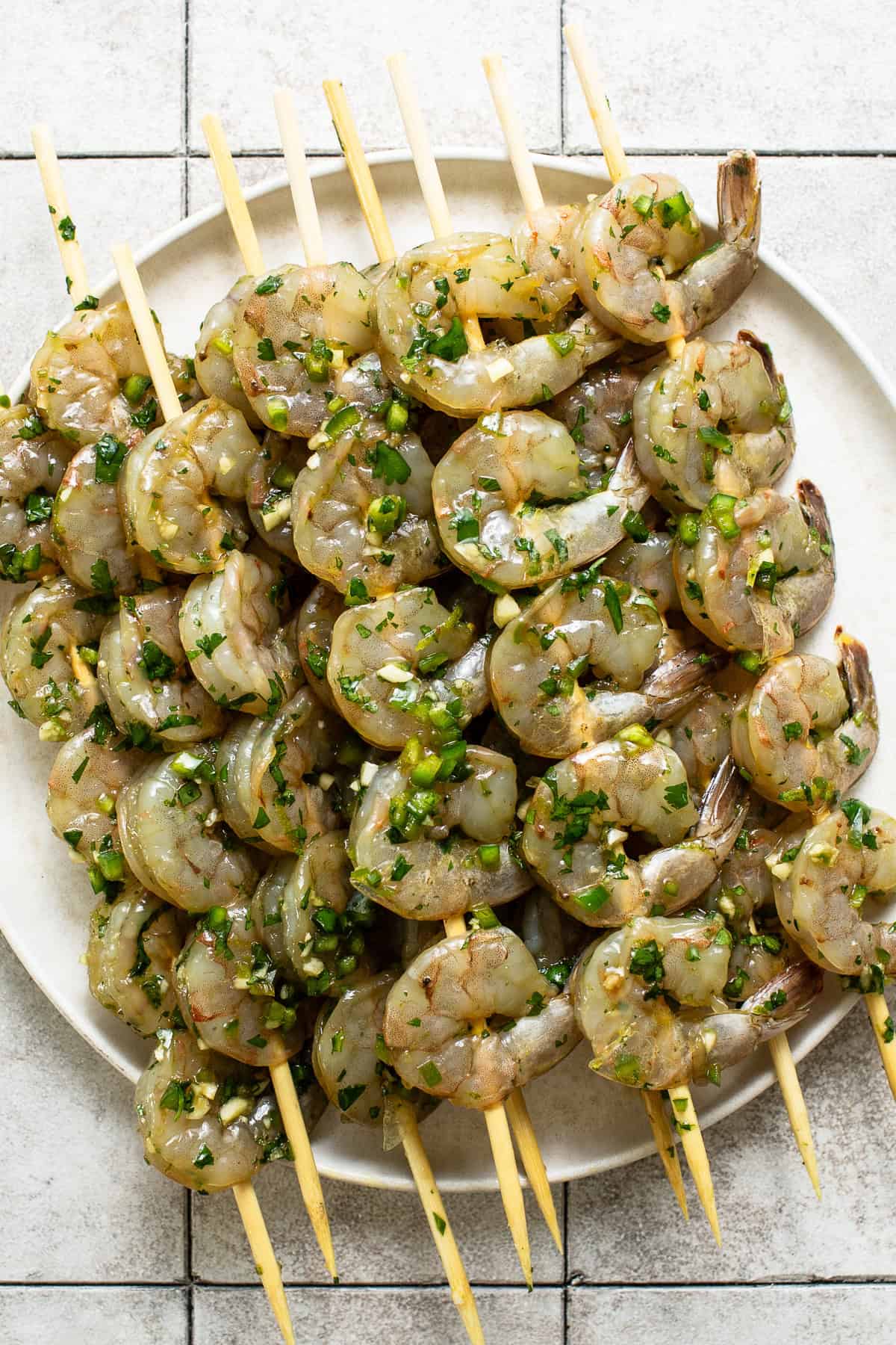 Four to six marinaded shrimp added onto  skewer sticks.