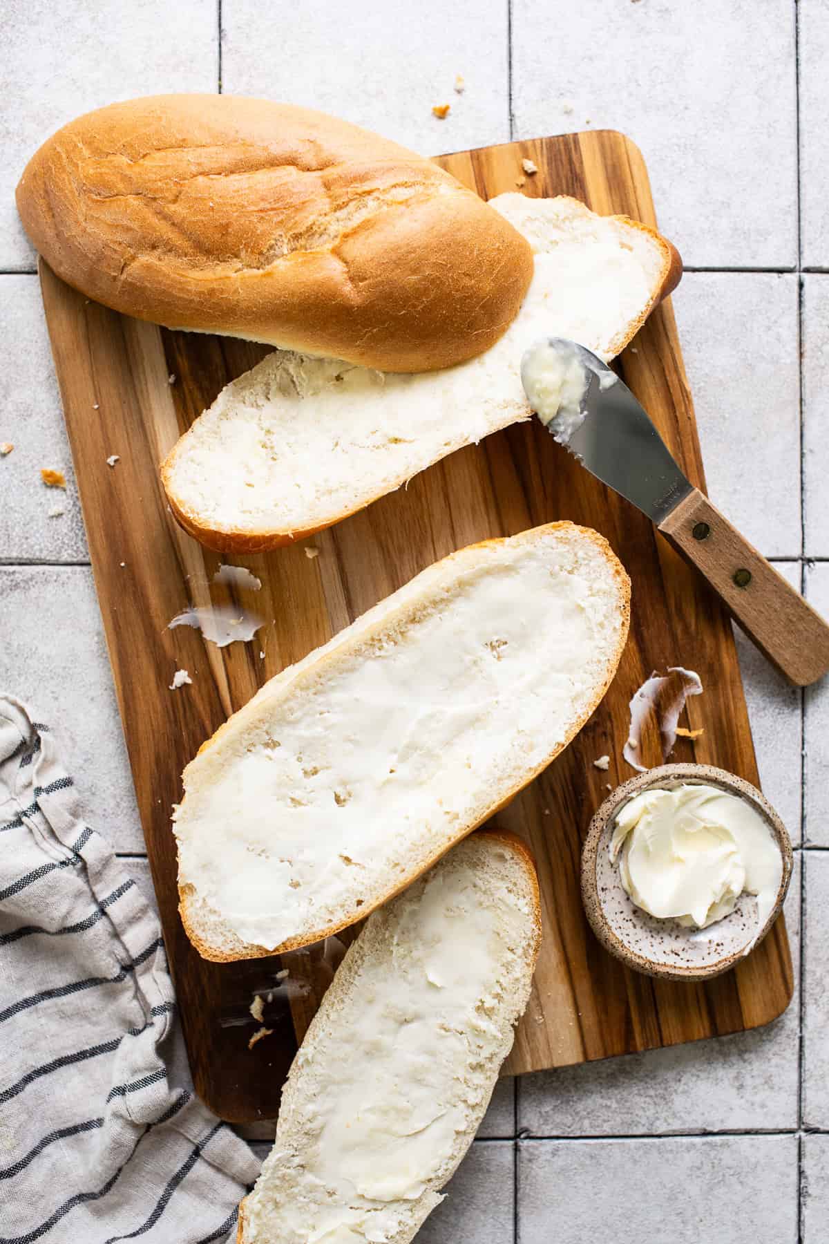 Butter spread on bolillo bread to make molletes.