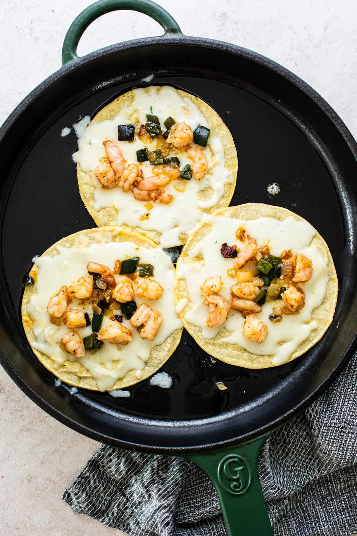 Frying tacos with filling and cheese