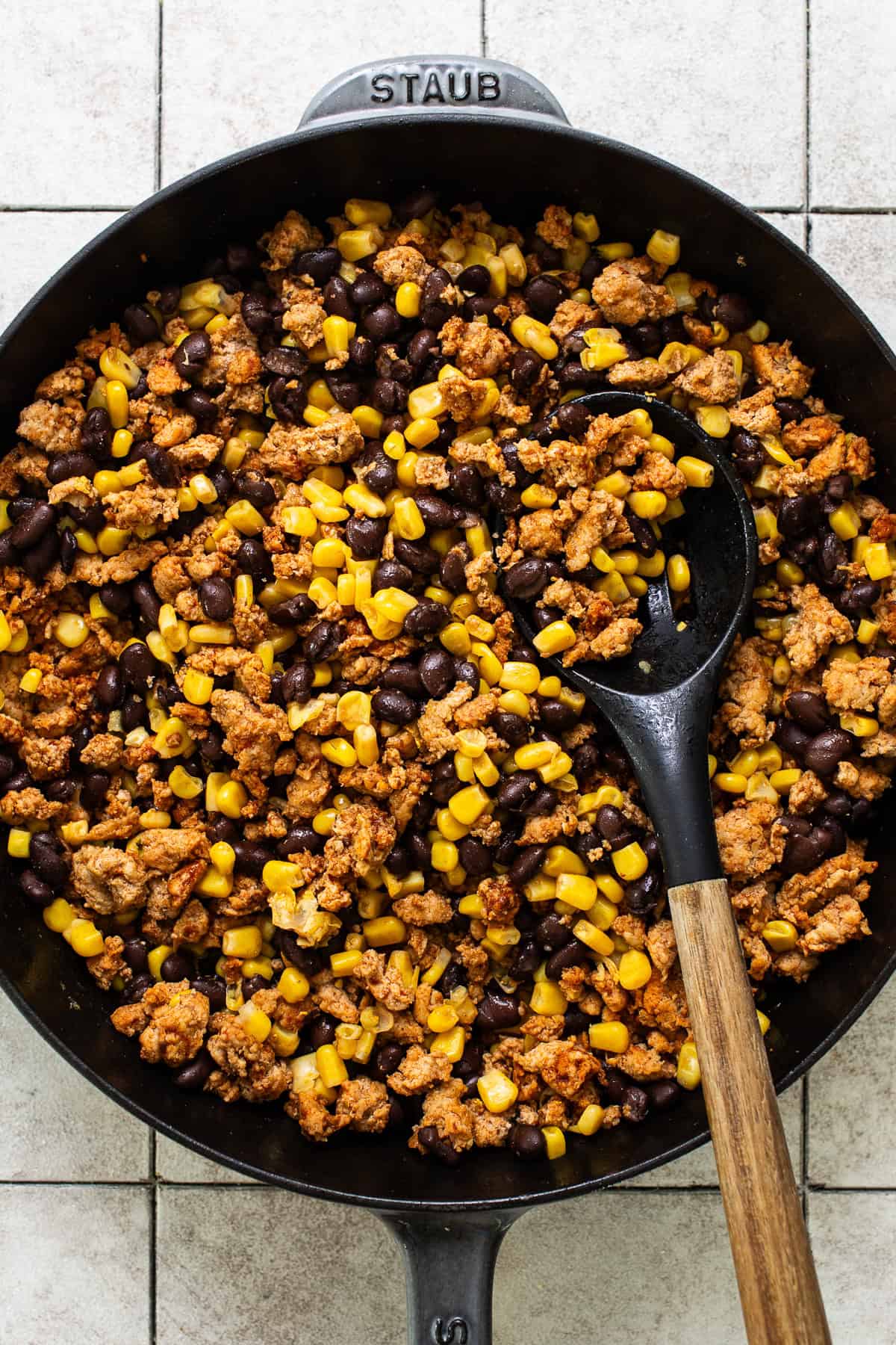 Ground beef, corn, and black bean filling for bell pepper nachos in a large skillet.