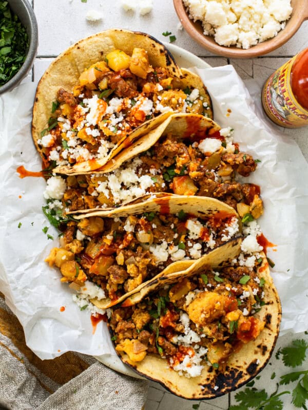 Breakfast Tacos on a plate with chorizo, potatoes, and eggs.