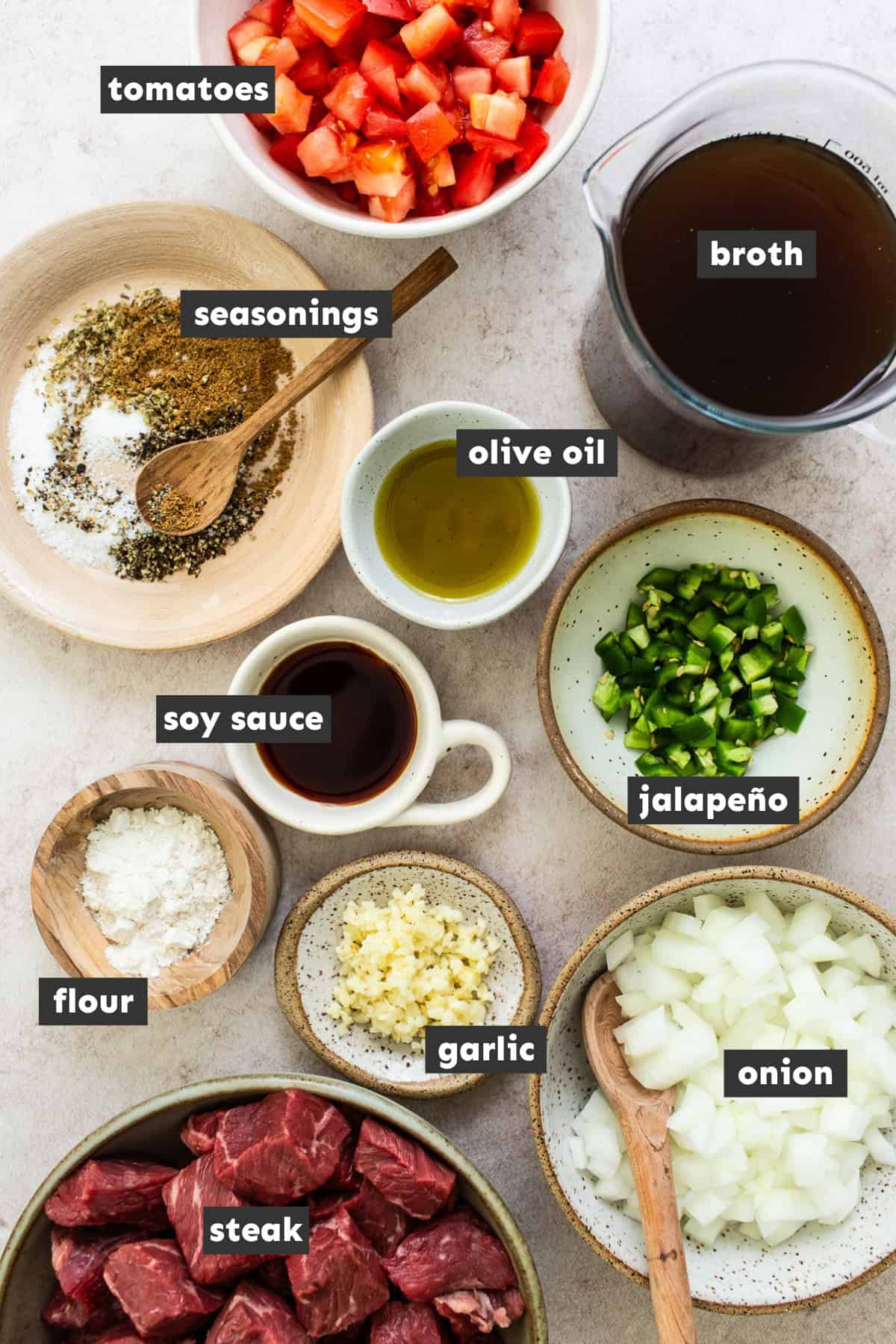 Carne guisada ingredients measured and laid out on a table ready to cook