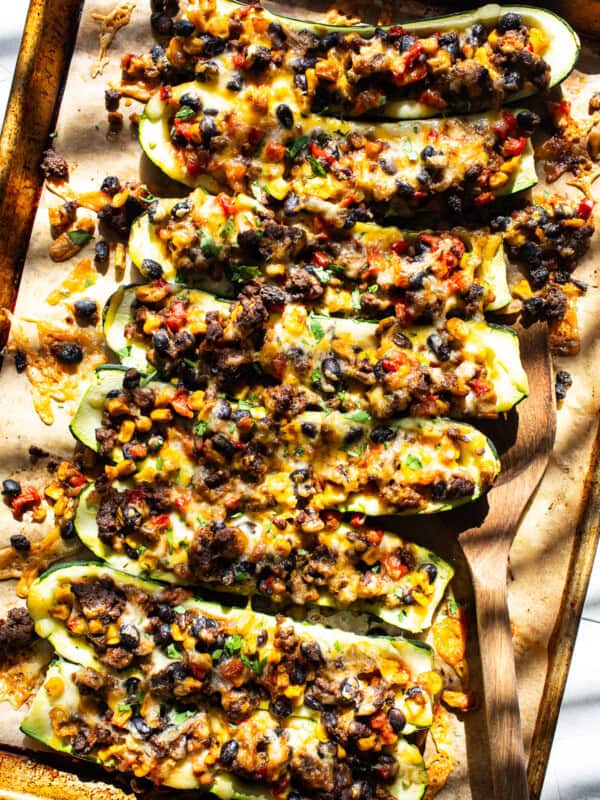 Stuffed zucchini boats filled with black beans, corn, cheese, and salsa.