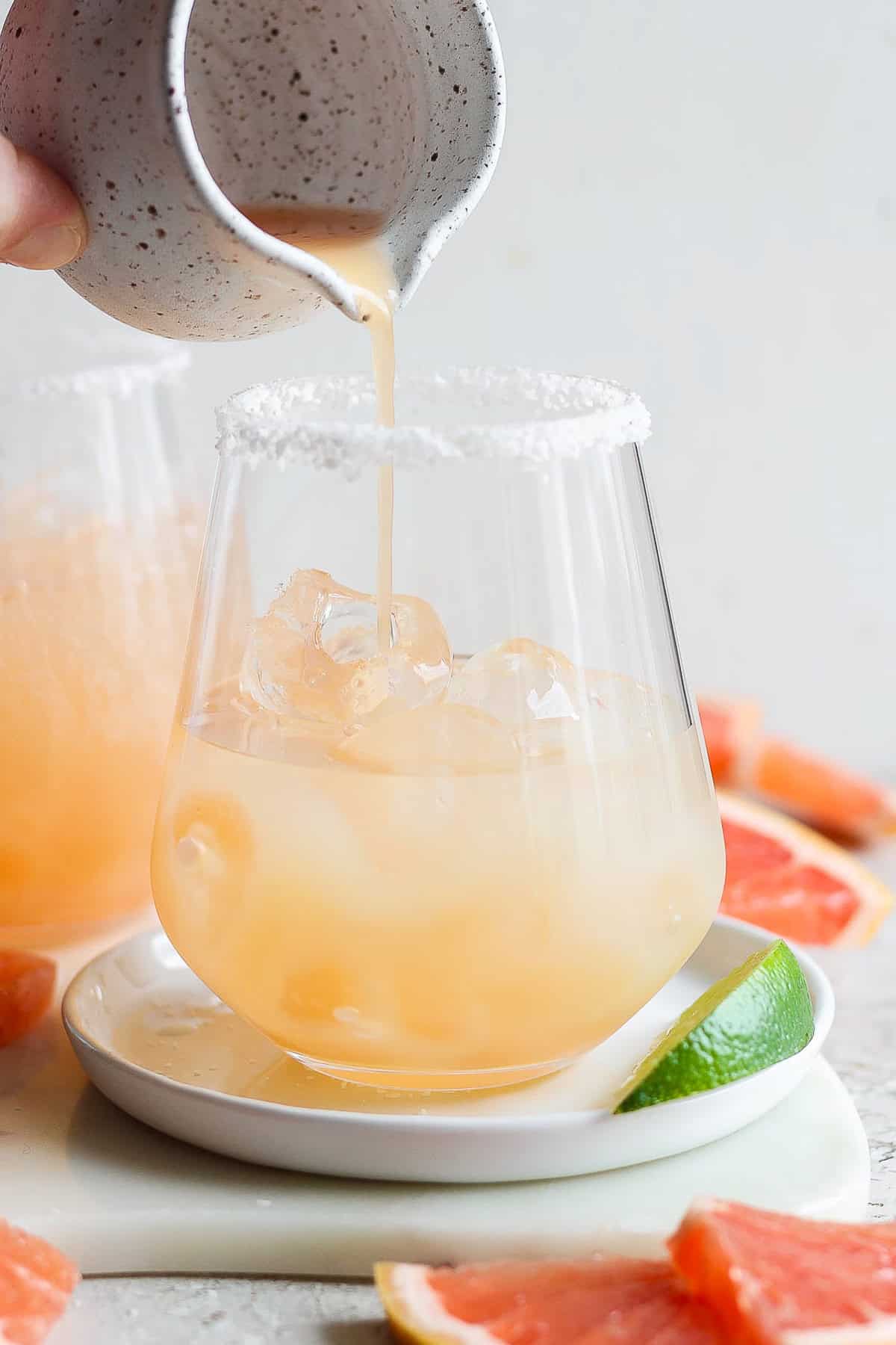 To a glass add tequila, grapefruit juice, and lime juice