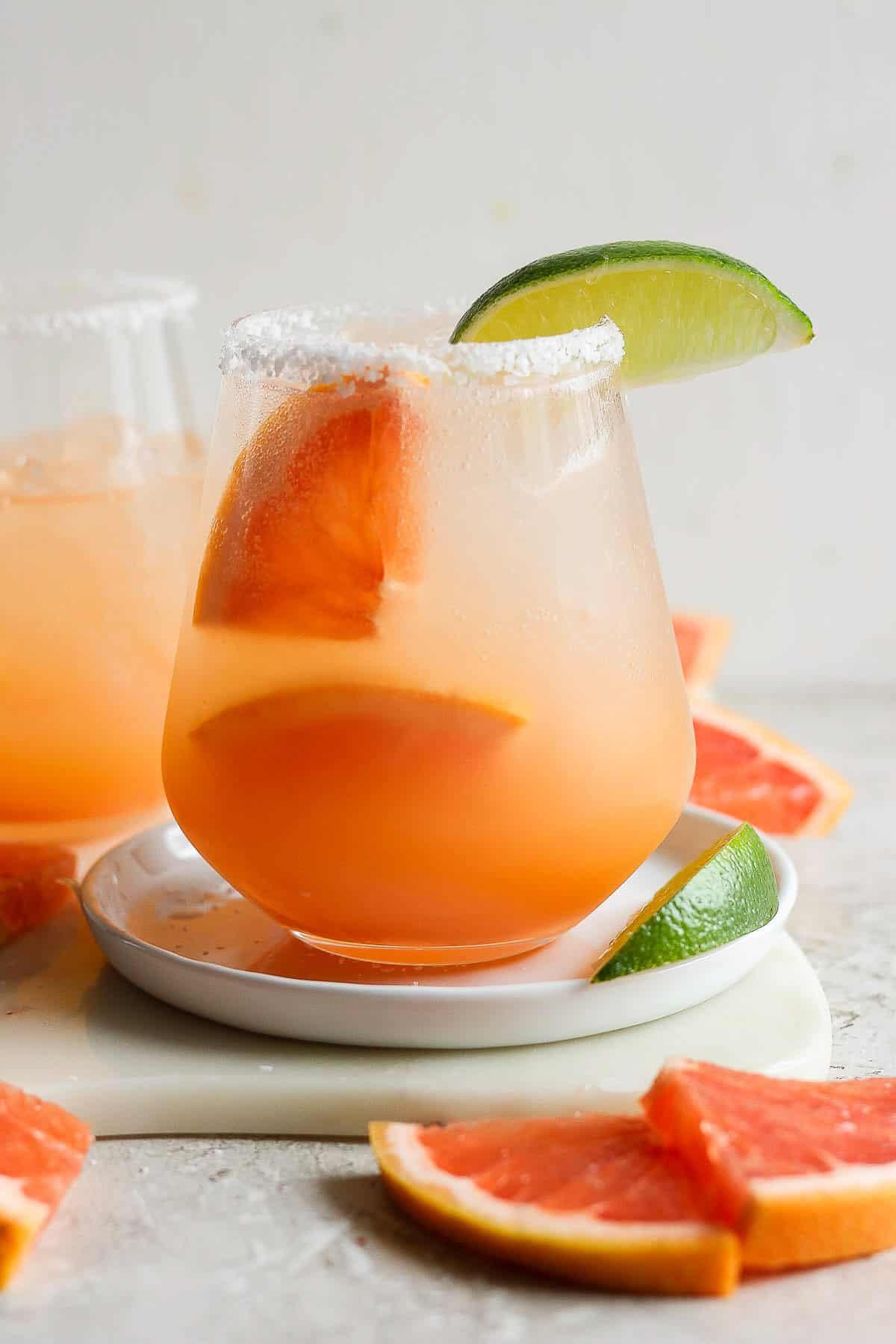 Paloma served in a glass with a lime garnish