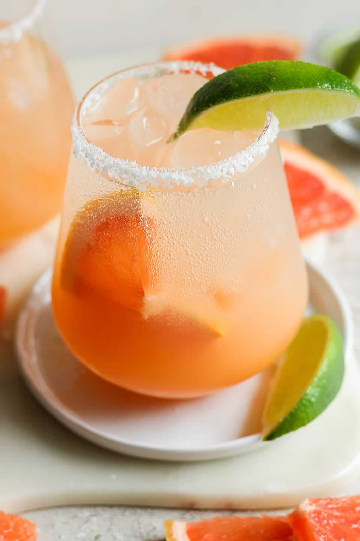 Paloma served in a glass with a lime garnish