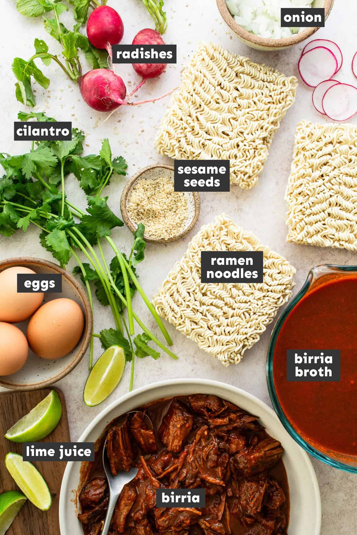 Ingredients for birria ramen laid out on a table ready to use. 