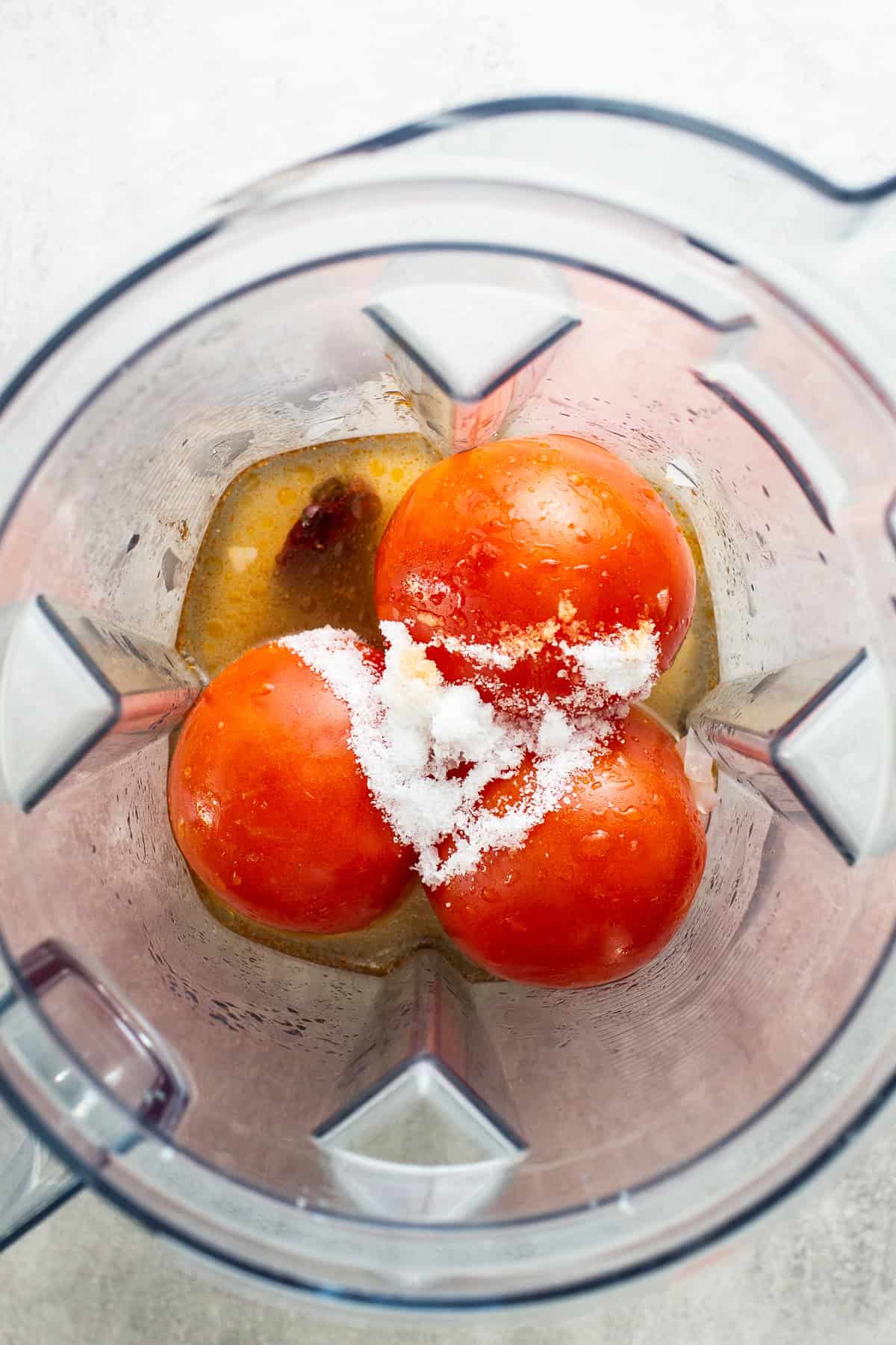 Roma tomatoes, salt, and broth in a blender to make a broth for caldo tlalpeño.