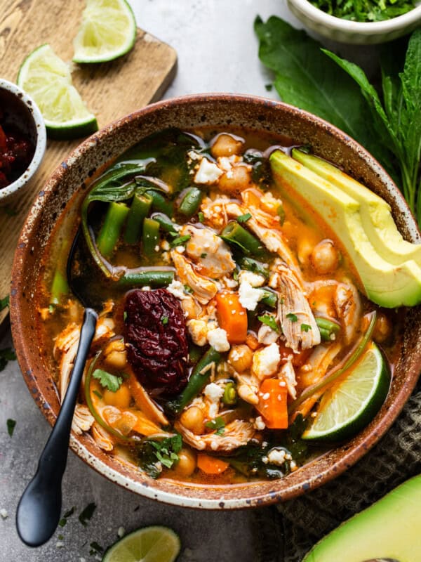 Caldo tlalpeño in a bowl garnished with queso fresco.