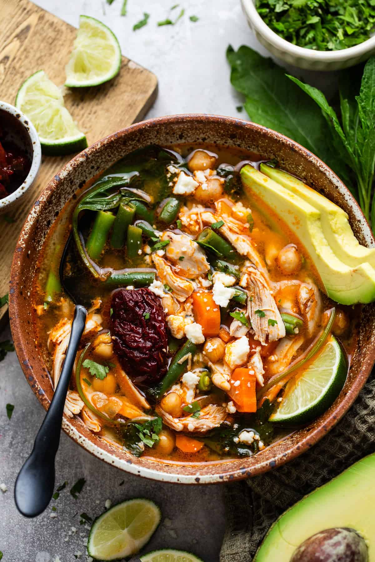 Caldo tlalpeño in a bowl garnished with queso fresco.